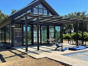 HOA clubhouse exterior by Jeff Smith Construction in El Dorado Hills. Completed exterior of an HOA community clubhouse with poolside access, built by Jeff Smith Construction in El Dorado Hills, CA.