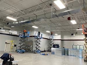 Warehouse interior construction in Woodland by Jeff Smith Construction. Interior view of a warehouse with industrial lighting and concrete flooring completed by Jeff Smith Construction in Woodland, CA.