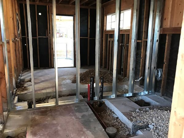 Commercial framing and tenant improvements in Loomis by Jeff Smith Construction. Side view of a commercial building interior showing steel and wooden framing during tenant improvement work in Loomis, CA.