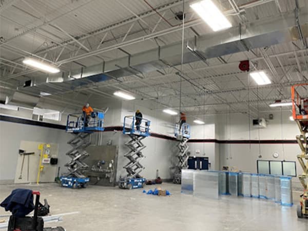 Warehouse interior construction in Woodland by Jeff Smith Construction. Interior view of a warehouse with industrial lighting and concrete flooring completed by Jeff Smith Construction in Woodland, CA.